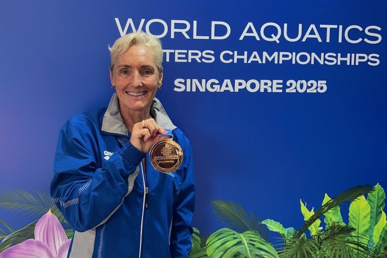 senior woman holding gold medal at World Aquatics Masters Championships Singapore 2025