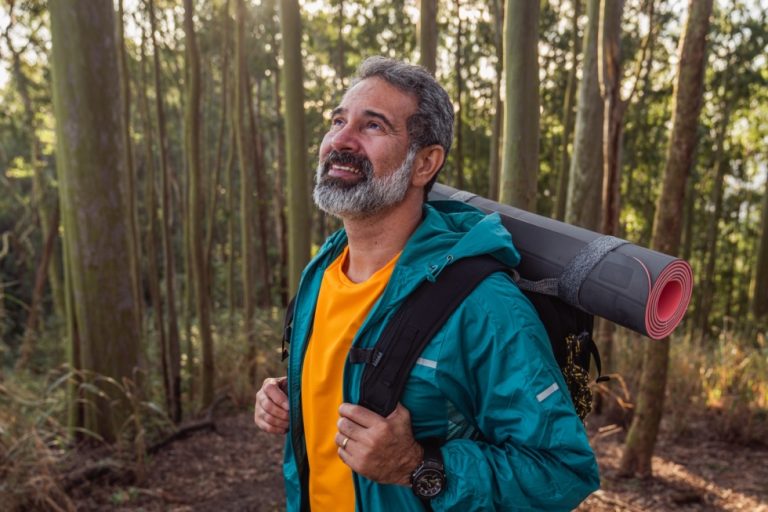 man hiking in the woods solo