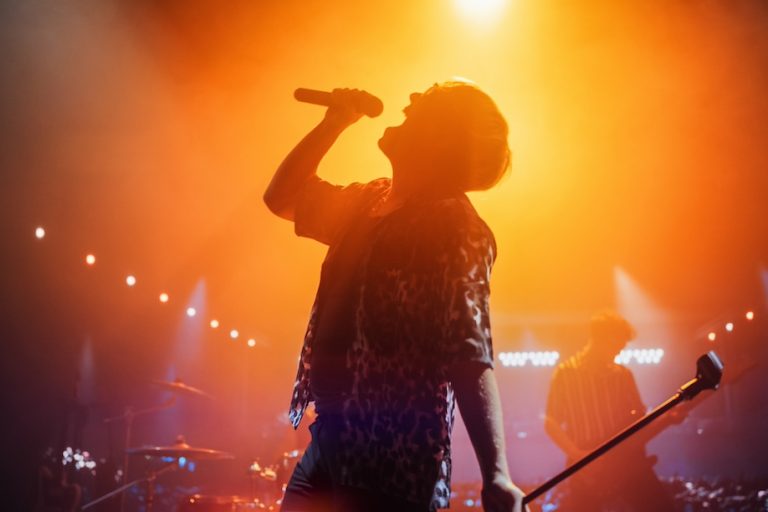 Energetic Rock Band Performing on a Nightclub Stage with Dynamic Lights and Special Effects