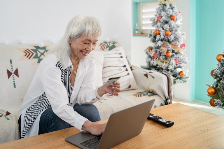 senior woman shopping online at Christmas