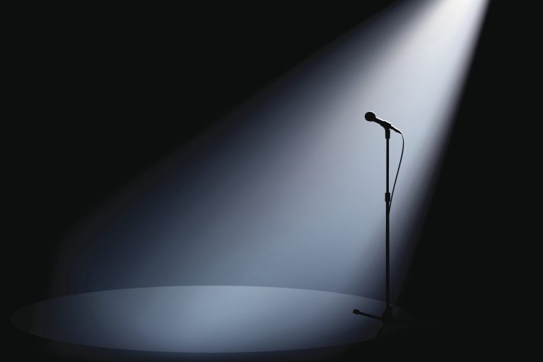 spotlight on an empty microphone on stage