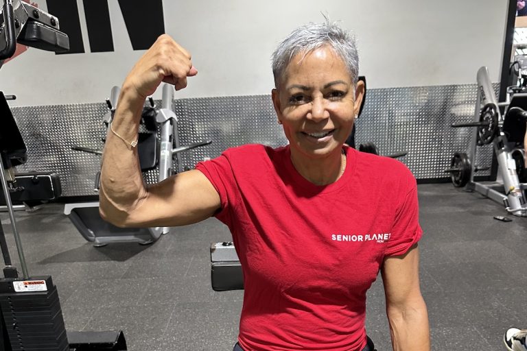 senior woman flexing arm muscle