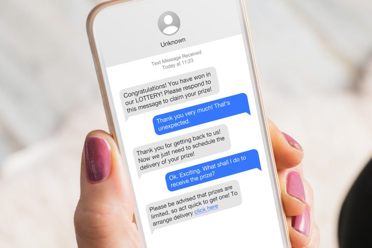 woman receiving scam messages on her mobile phone